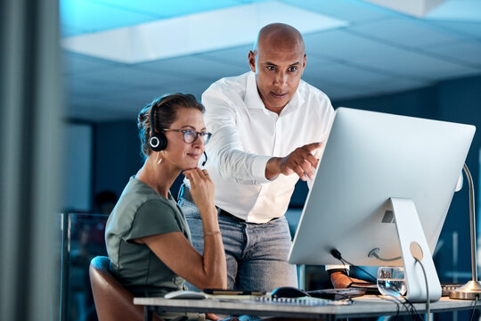 Leadership, training and manager in call center coaching a telemarketing employee for quality customer services. Contact us, crm and mentor teaching an insurance agent on new job tasks on a computer