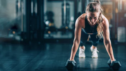  Woman Doing Push-ups with dumbbells © Microgen
