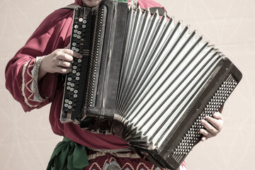 A man plays the button accordion.