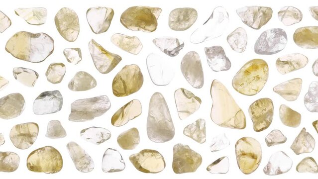 Citrine jewel stones set texture on light white isolated background. Macro closeup. Moving right seamless loop backdrop.