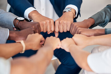 Hand, Fist or diversity business men and women teamwork together in mission, trust or goal in top view. Hands of business people support, team building or strategy meeting in corporate global success