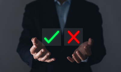 Businessman's hands showing checks marks and wrong