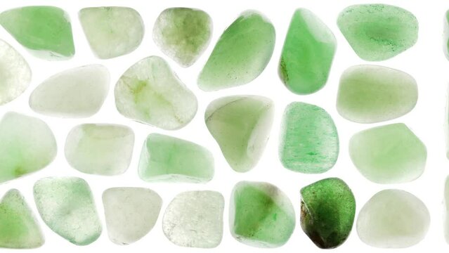 Green Aventurine jewel heap set texture on white light background. Moving right seamless loop backdrop.