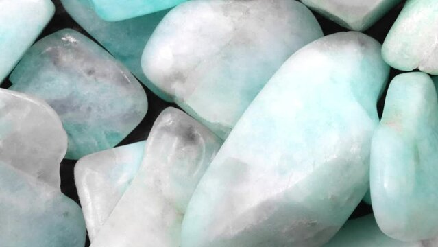 Amazonite jewel heap texture. Pile mineral pebbles background. Moving right seamless loop backdrop.