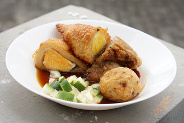 Pempek is a savoury Indonesian fishcake delicacy, made of fish and tapioca from Palembang. Pempek is served with sweet and sour sauce.