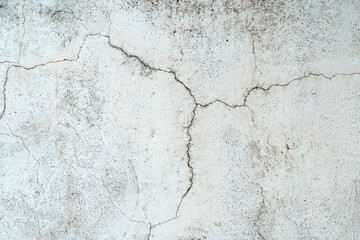 Old concrete stone wall covered with cracked plaster and dirty grunge textured surface.