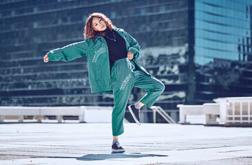 City, dance and dancing woman on a rooftop with cool hip hop street fashion and creative artistic freedom. Balance, moving and young girl dancer in training, cardio workout and body exercise outdoors
