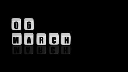 March 6th. Day 6 of month, Calendar date. White cubes with text on black background with reflection.Spring month, day of year concept