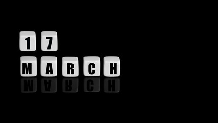 March 17th. Day 17 of month, Calendar date. White cubes with text on black background with reflection.Spring month, day of year concept