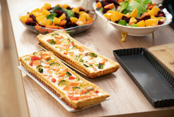 Ready-made quiche with salmon, broccoli and tomatoes. Cooking a pie.