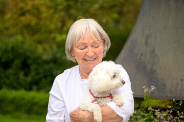 Elderly lady holding her dog