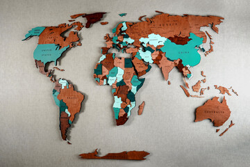 Wooden map of the world. Political color interior map of the world with countries on the wall. Laser cutting on plywood