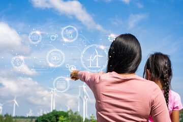 Wind turbines are an alternative electricity source to be sustainable resources in the future. People in the community with wind generators turbines. Clean energy concept saves the world