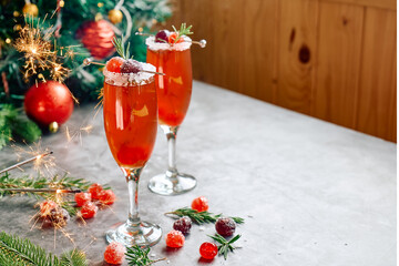 Christmas mimosa punch or cranberry margarita cocktail with cranberry juice, orange liqueur and...