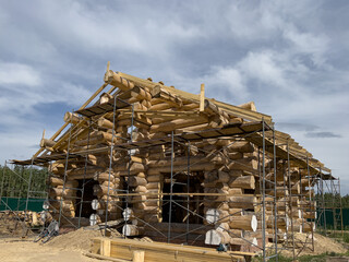 Construction of a wooden eco-friendly house made of pine logs.
