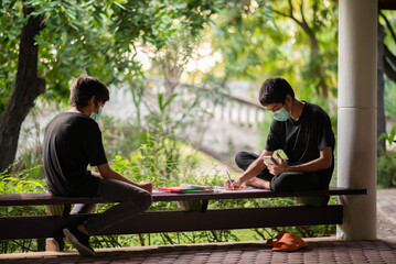 Boys draw and paint in the park