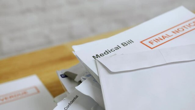 Close up of a pile of bills and letters with a medical bill final notice for healthcare