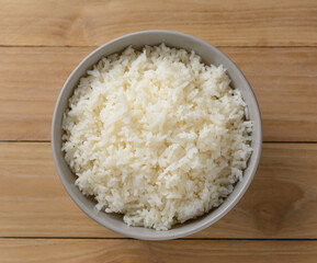 cooked rice on bowl on wooden table background, Jasmine rice cooked. top view
