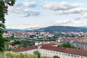 Fototapeta na wymiar Panorama view of the skyline of the Galician city of Ourense as seen from the outskirts, with the three main bridges to be recognized.