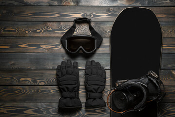 Snowboarding equipment on the wooden flat lay background with copy space.