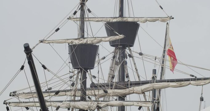 Ferdinand Magellan Nao Victoria carrack boat replica spanish flag masts and sails detail shot in slow motion 60fps