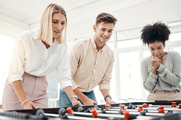 Business people, foosball table and competition in office for team building, motivation and...