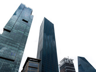 Modern tower buildings or skyscrapers in financial district with cloud on sunny day. bottom view