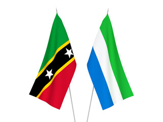 National fabric flags of Sierra Leone and Federation of Saint Christopher and Nevis isolated on white background. 3d rendering illustration.