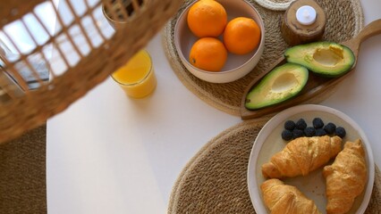 Top view for breakfast, breakfast with croissants, vegetables and fruits, everything you need to keep the body in good shape and maintain health. Proper nutrition with a high content of vitamins.