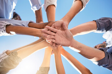 Low angle, hands and circle in success, solidarity or support team building, teamwork collaboration or diversity celebration. Men, women and friends in community huddle for business motivation goals