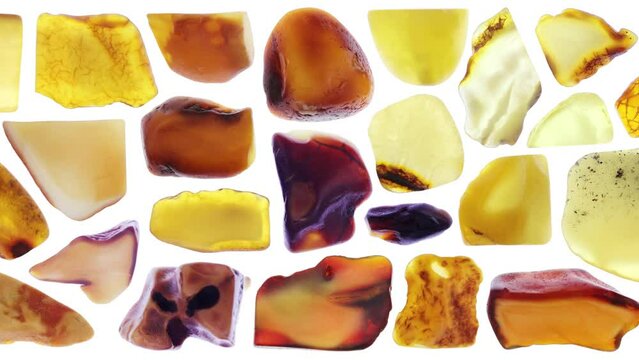 Amber jewel stones set texture on black background. Moving right seamless loop backdrop.