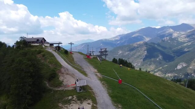 An aerial shot of a ski lift in the French Alphs during the summer.