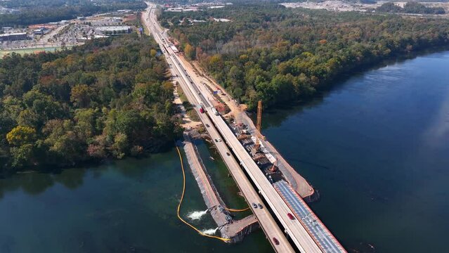 Savannah River forms border between state of Georgia and South Carolina. Bridge under construction on Interstate 20, I-20, aerial view. Civil engineering theme.