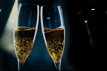 two glasses of champagne and holiday lights - new year celebration