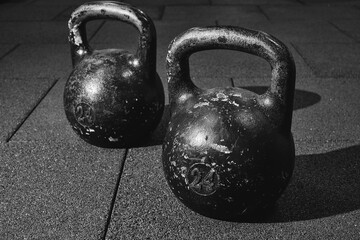 Fototapeta na wymiar sports kettlebells for weight training. Bodybuilding equipment. Fitness or bodybuilding concept background. black and white photography