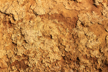 Close up surface of orange brown clay texture of a cliff