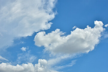 Naklejka na ściany i meble White clouds against blue sky for a backgrounds.