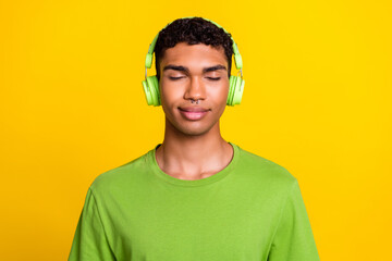 Photo portrait of handsome young guy feel calm peace listen classical music dressed trendy green...