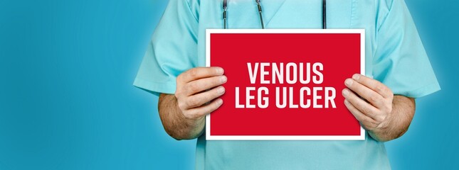 Venous leg ulcer. Doctor shows red sign with medical word on it. Blue background. - obrazy, fototapety, plakaty