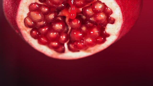 Slow Motion of Juice Drip Drop from Half Pomegranate