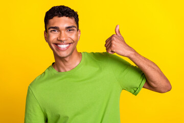 Photo portrait of handsome young man smile show thumb up positive feedback wear stylish green...