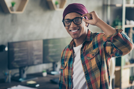 Photo of smiling cool businessman dressed hat glasses showing smiling front engineer work indoors workplace workstation loft