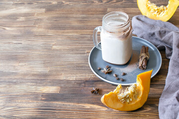 Latte coffee cacao with milk, pumpkin in glass cup, mug,hot warm autumn traditional beverage recipe