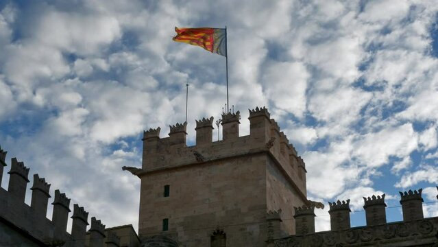 Waving spanish flag on the cathedral roof. Valencia, Spain.