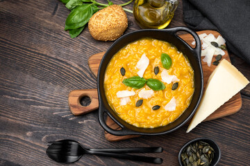 Risotto with pumpkin and pumpkin seeds, parmesan cheese and basil. risotto alla milanese with...