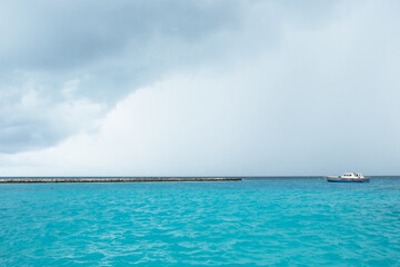 Fototapeta na wymiar The monsoon season of Rasdhoo, with heavy gray cloud and rain, Maldives.