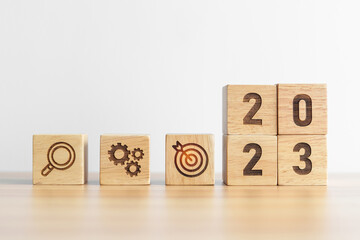 2023 wood block with business goal, plan. Action strategy, target, mission, teamwork, idea and New...