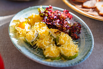 fried zucchini with cheese. a table served with utensils and snacks for lunch.