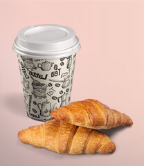 Coffee paper cup with fresh tasty croissant