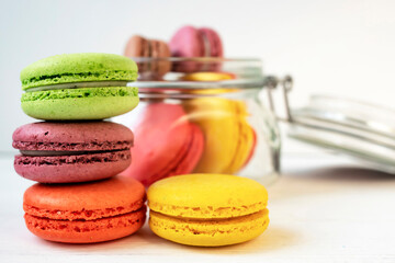 Sweet colorful macarons, on a white background. Delicious colorful macaroons. Side view, space for text.